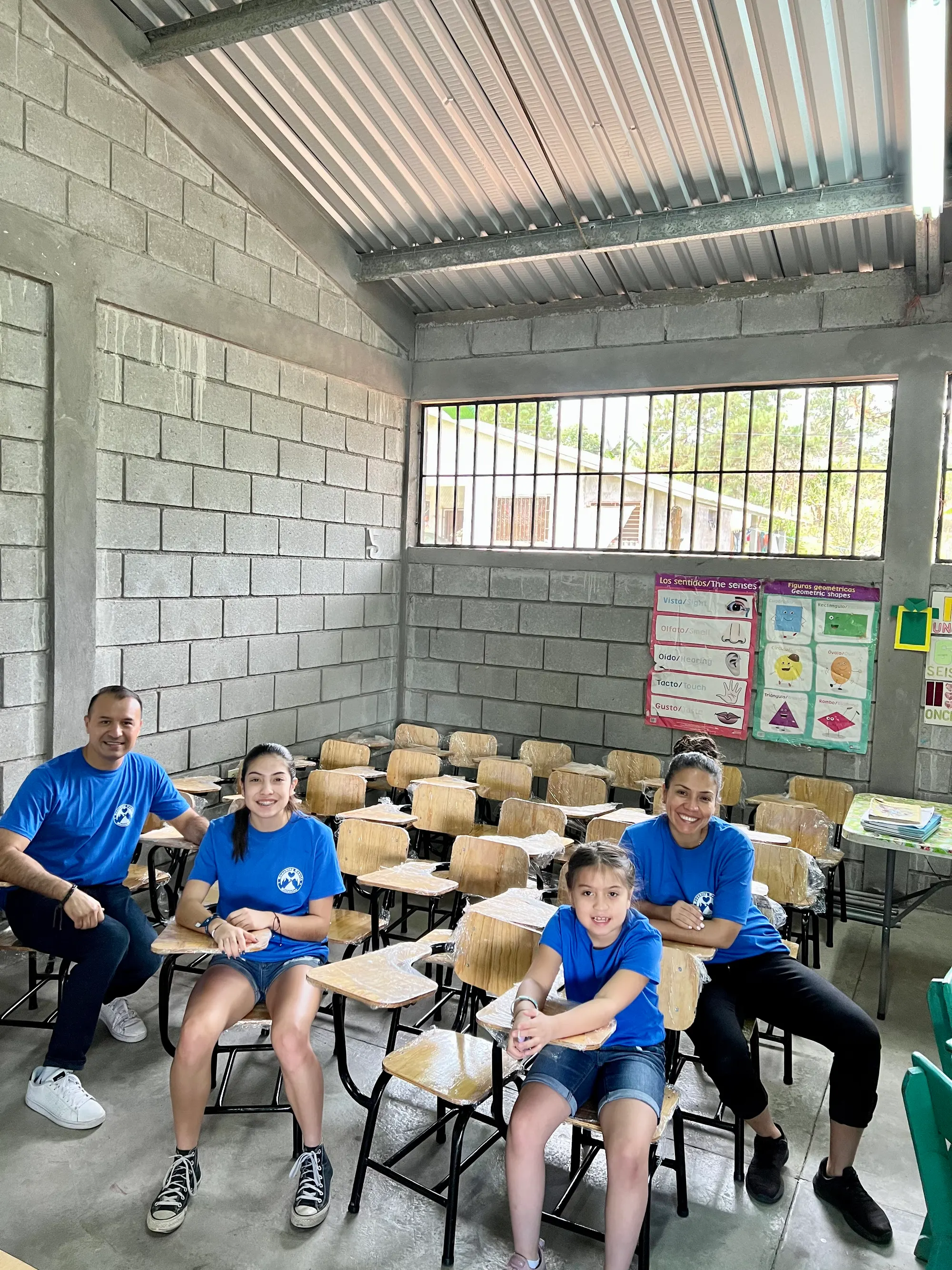 A family in Honduras with new school desks