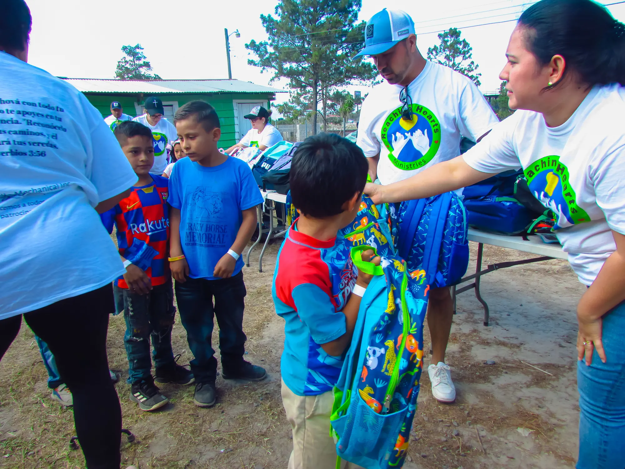 Children receiving new backpacks at a ministry event in Honduras