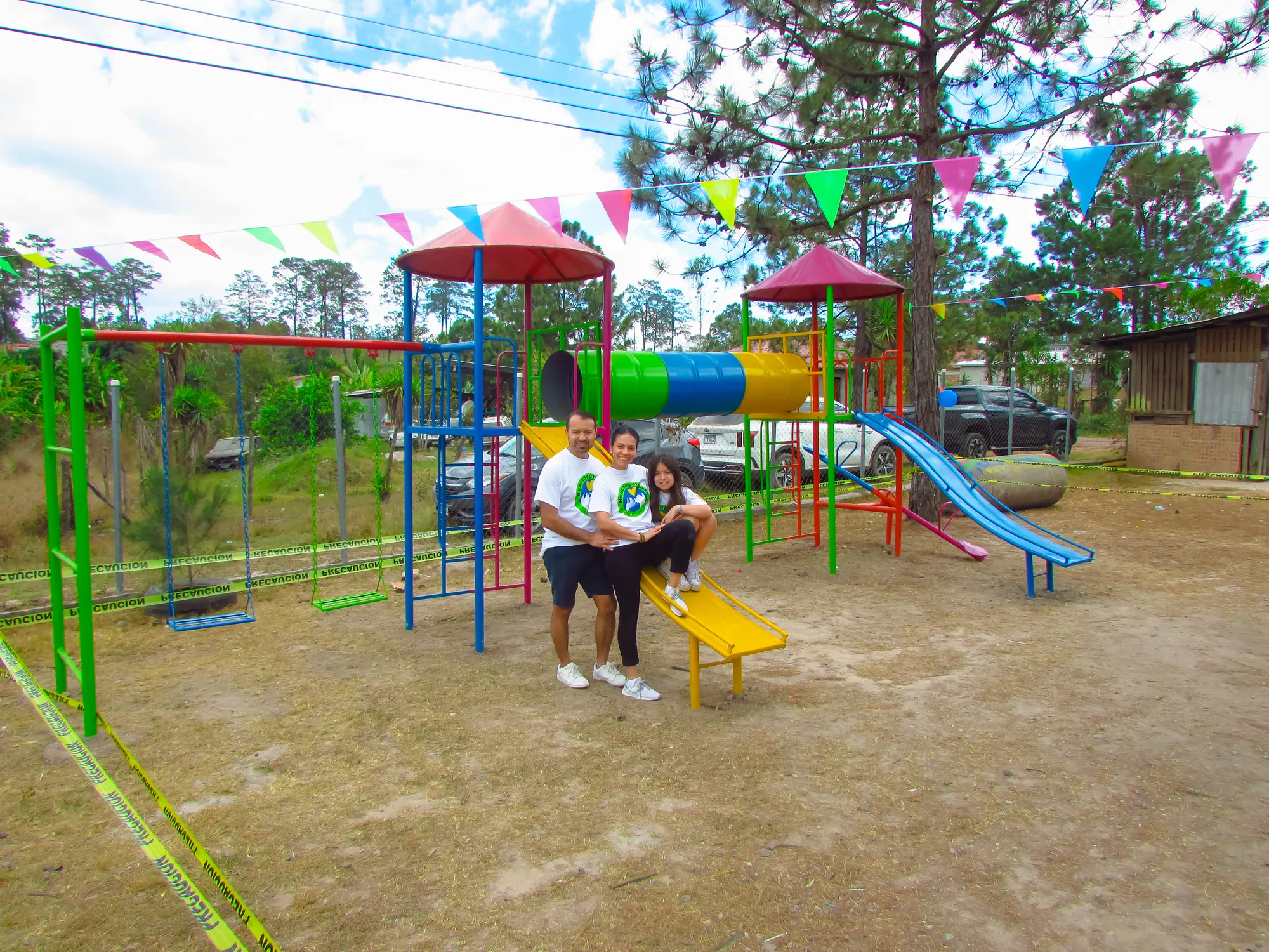 A family enjoying a new swing set in Honduras