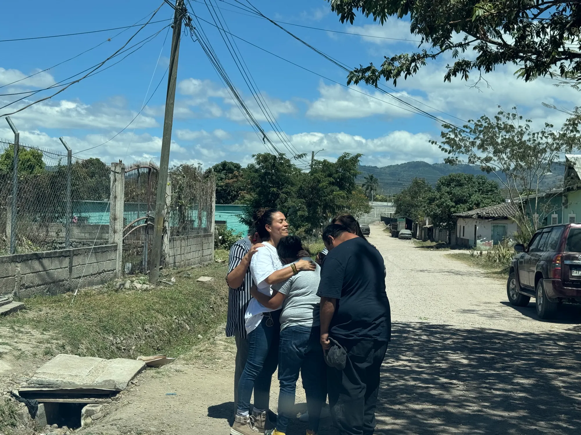 A group gathered in prayer on a street in Honduras
