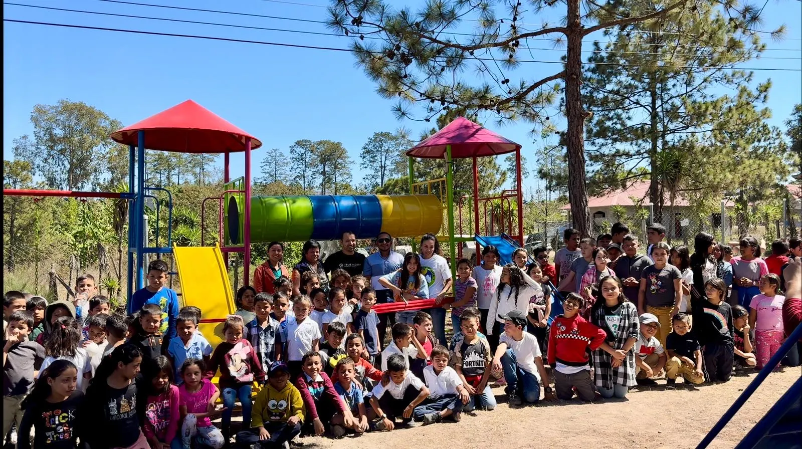 Students in front of a new swing set at their school in Honduras