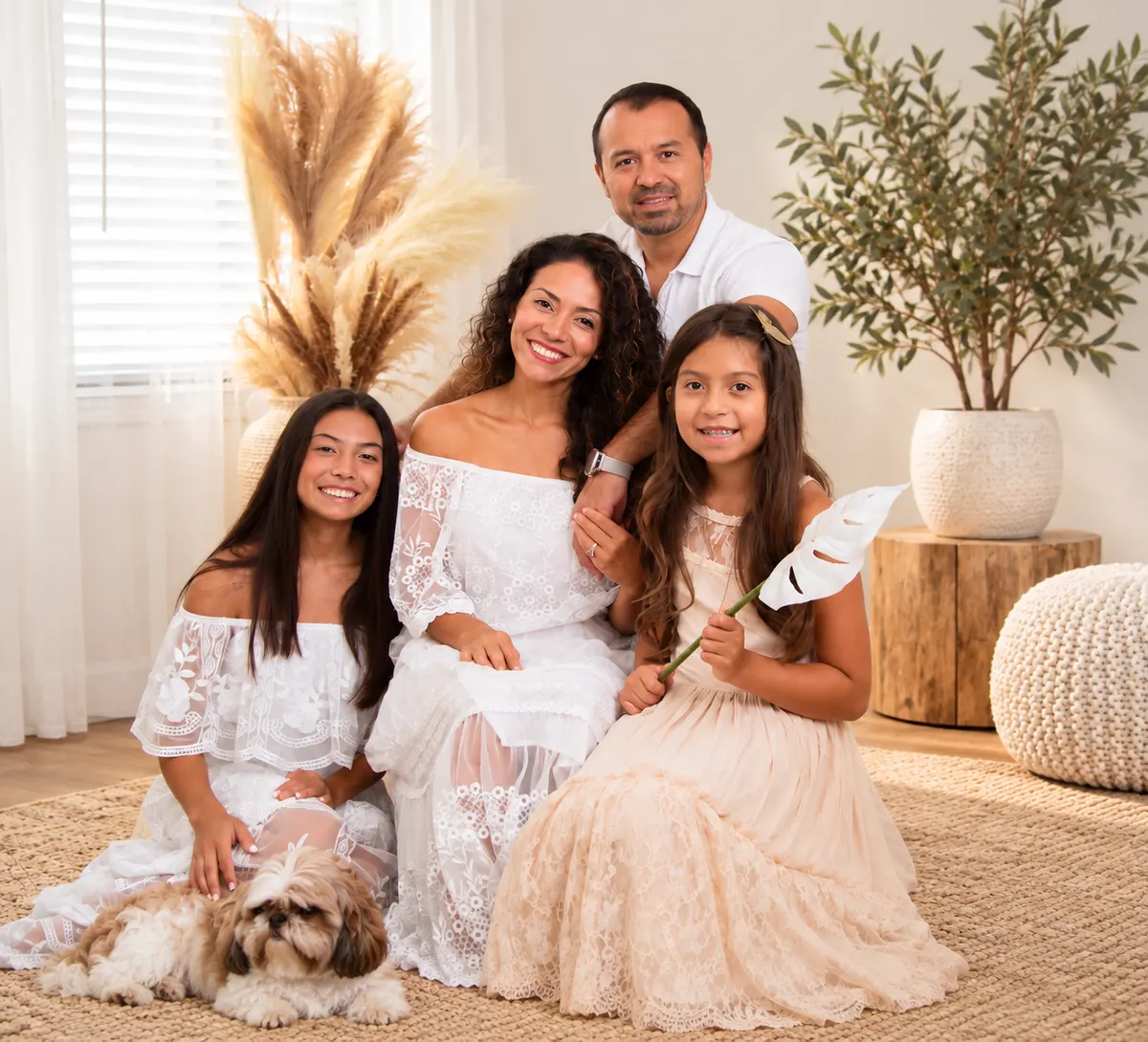 The founding family of Reaching Hearts Ministries dressed in white in a family portrait with their dog